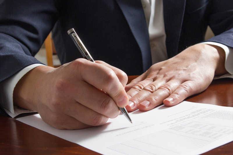 Client signing estate planning documents with their attorney in Marble Falls, Texas