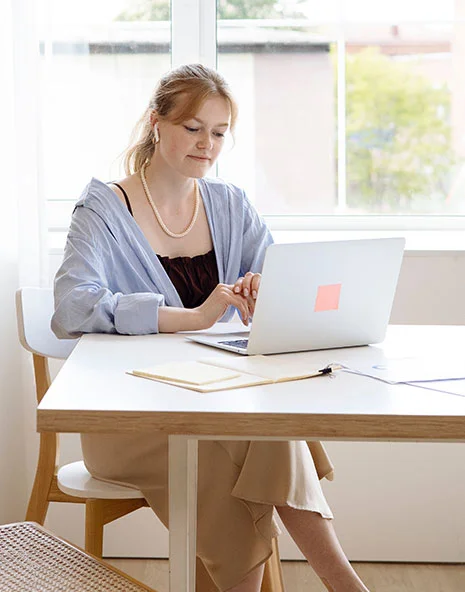 A client reviewing estate planning paperwork on a laptop before her consultation with H. Bryan Hicks